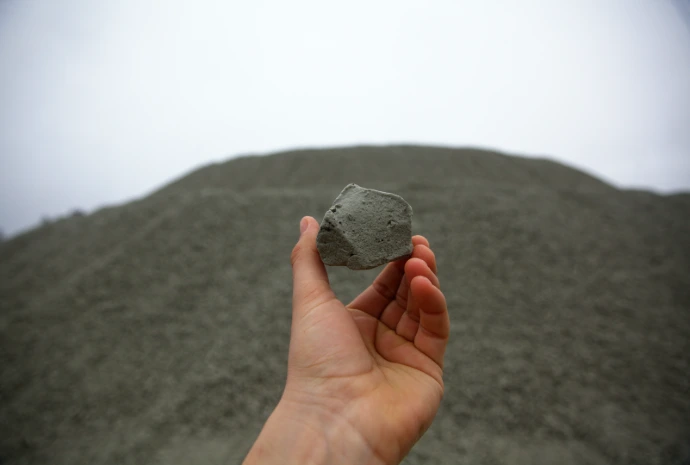 Photo of a hand holding a piece of Enviro-Rock foam glass aggregate