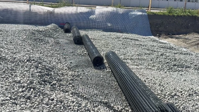 Photo of Enviro-Rock and geo grid being used to replace heavy soil over deep, compressible clay